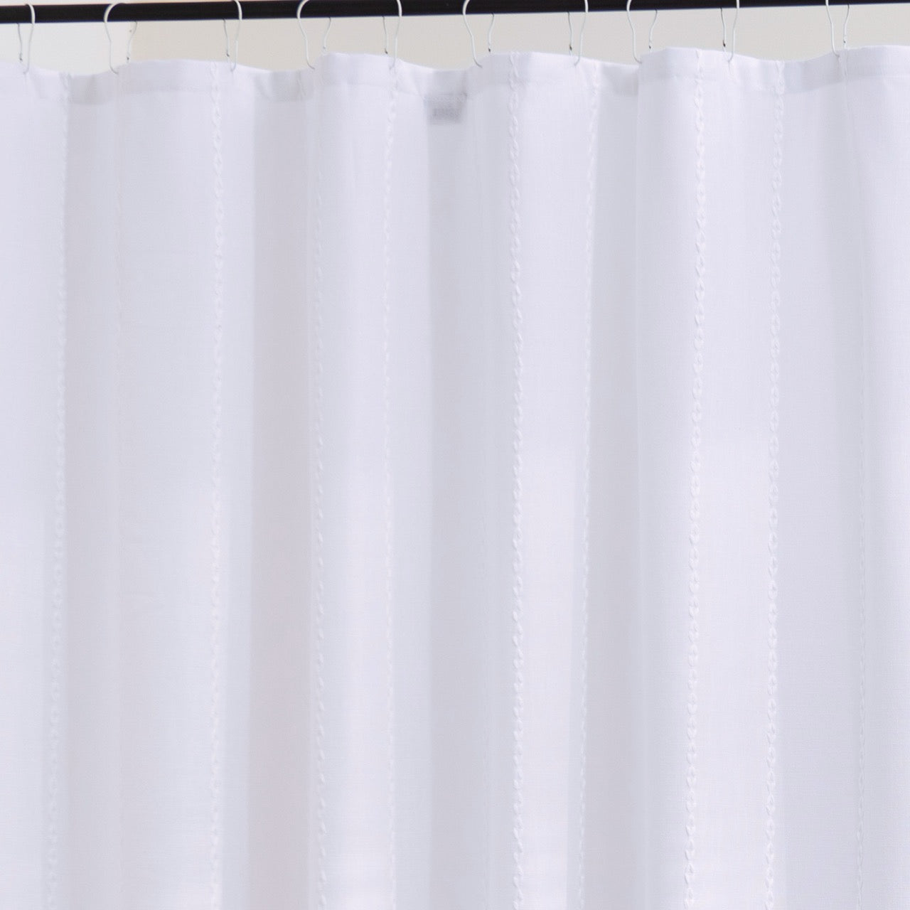Close detail of the ribbed white weave catching soft daylight