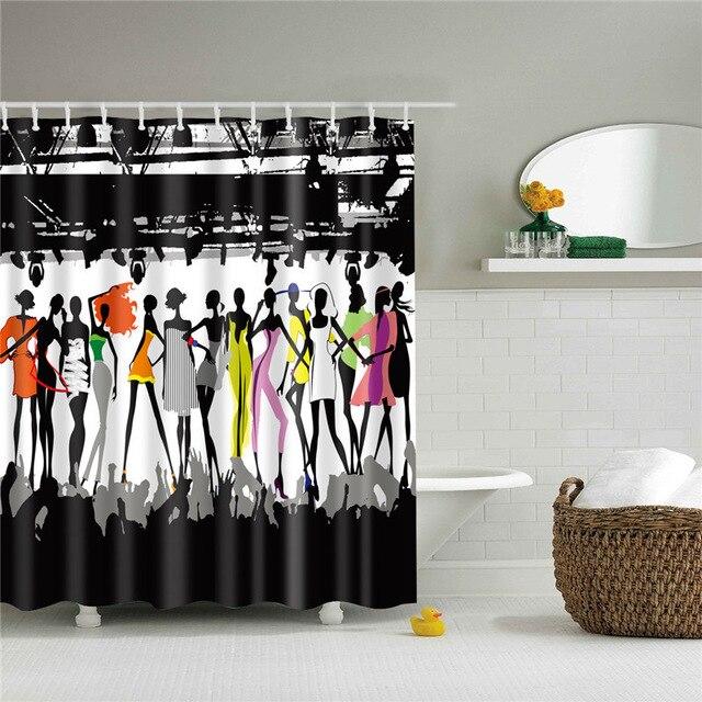 Line of runway model silhouettes in black grey and bright dresses before a skyline