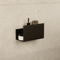 Small black stainless steel floating shelf mounted on a tiled shower wall