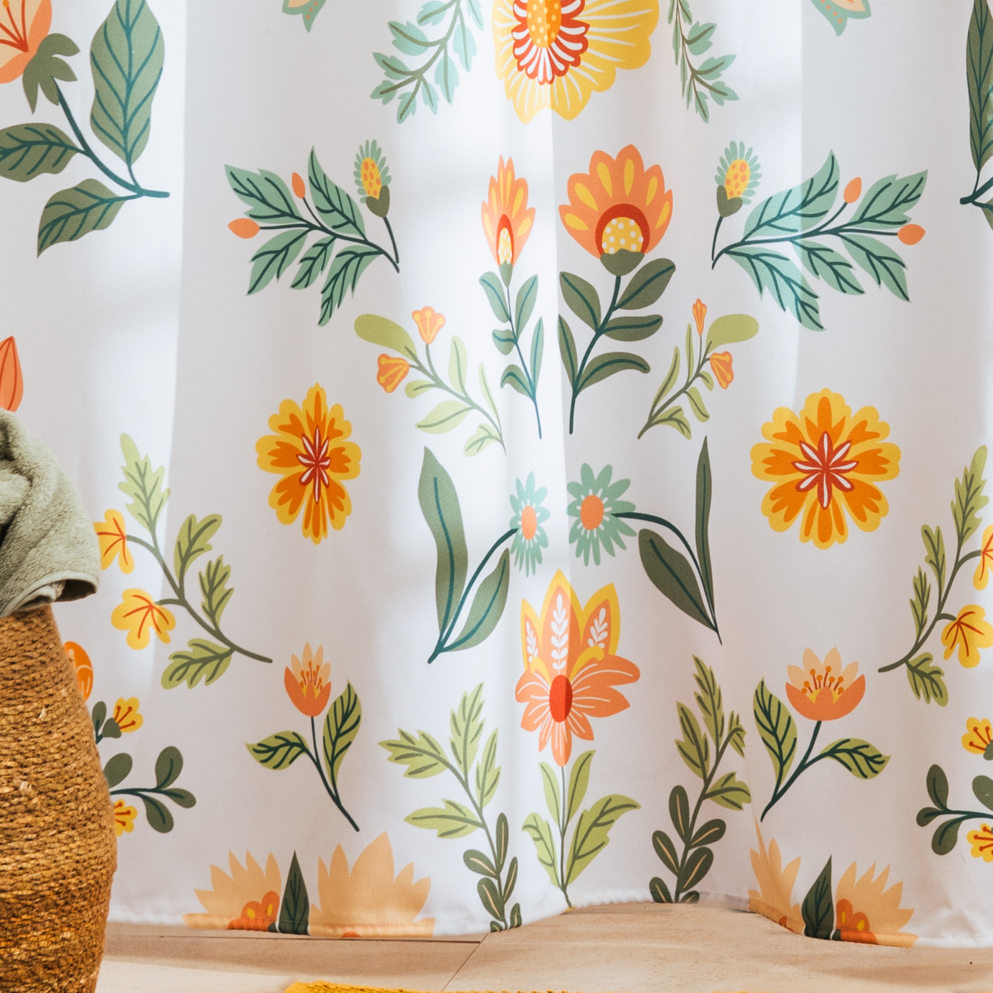 Full length floral curtain hanging beside a bathtub in daylight