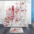 Pink flowering branches forming a wreath around a red long tailed bird