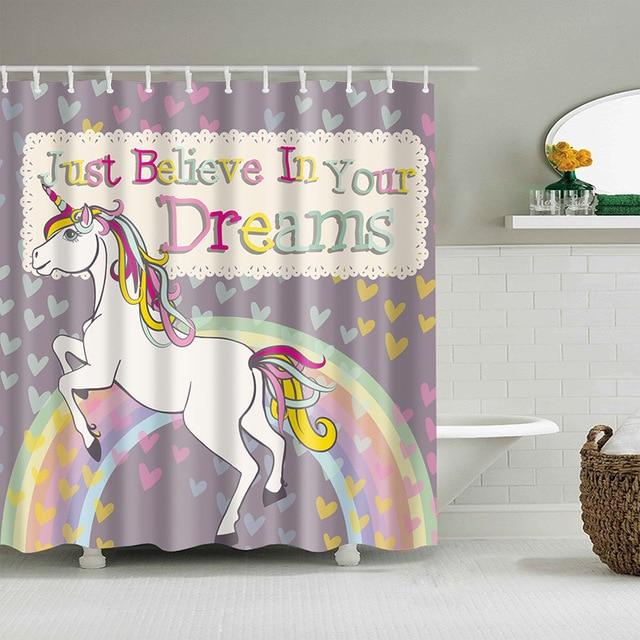 Rainbow-maned unicorn rearing on a pastel arc over a grey heart-strewn ground