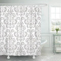 Grey baroque damask scrolls repeating regularly on a white matt woven ground