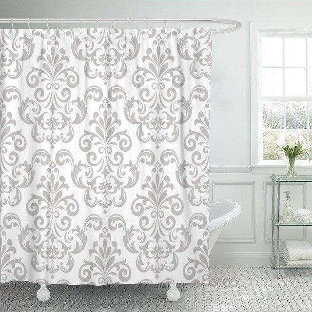 Grey baroque damask scrolls repeating regularly on a white matt woven ground
