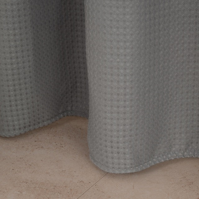 Even mid grey waffle panel hanging in a bright modern bathroom