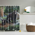 Dark brown bear in front of dense green woodland and shadowed tree trunks