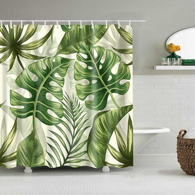 Large monstera leaves and green palm fronds on a creamy white background
