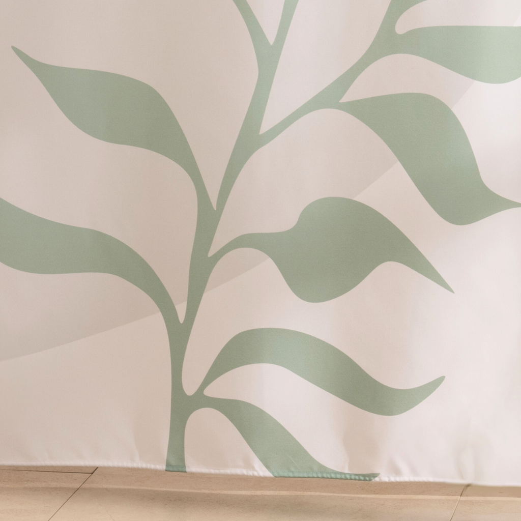 Full length sage branch curtain hanging beside a glass screen