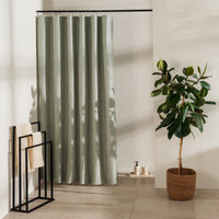 Muted sage green panel with a washed linen look visible in the folds