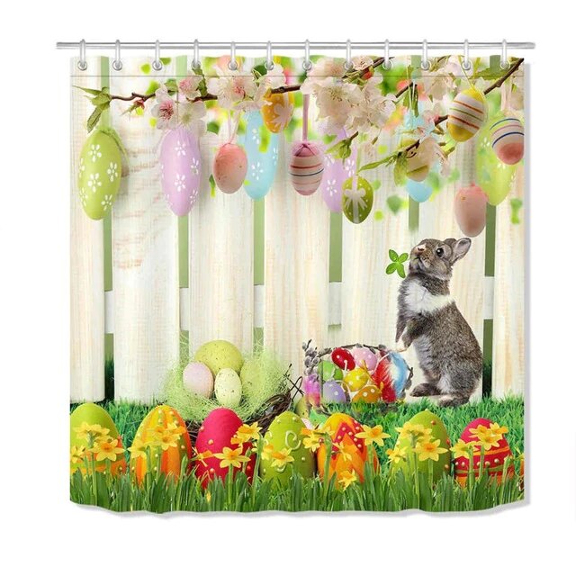 White picket fence with pastel eggs on blossom branches and a grey rabbit