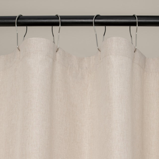 Weighted lower hem holding the ivory panel in a straight even fall