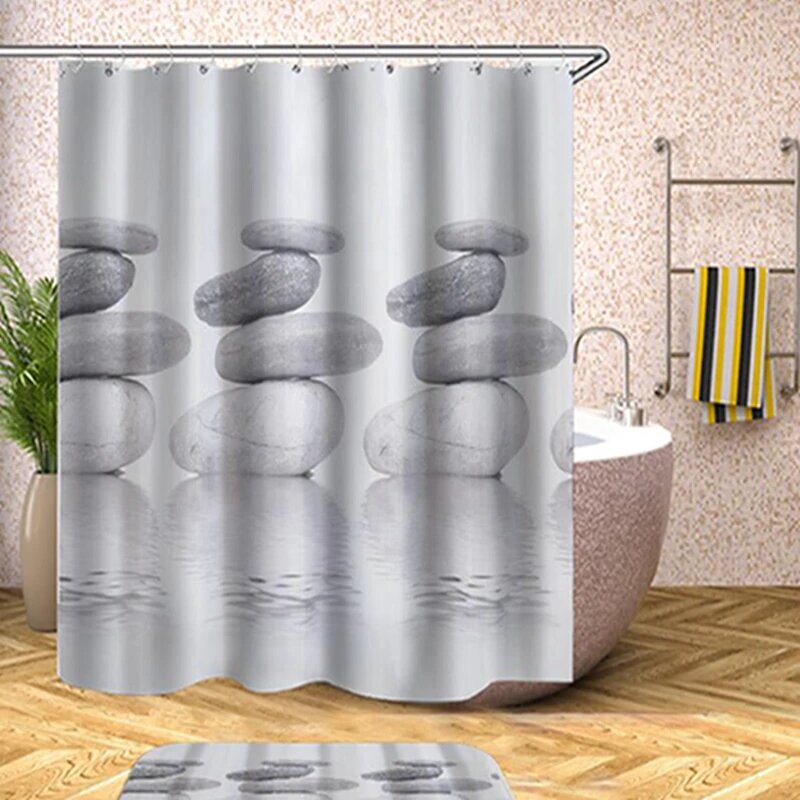 Three stacks of pale grey stones reflected in calm grey white water