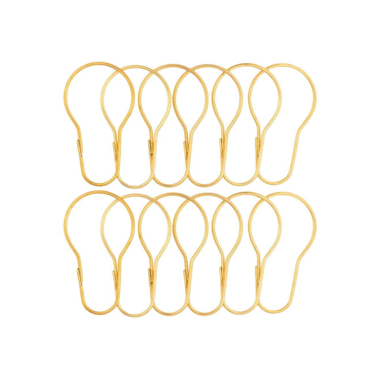 Twelve bright gold pear shaped curtain rings laid out in two rows