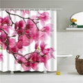Large fuchsia magnolia blooms on a brown branch crossing a white ground
