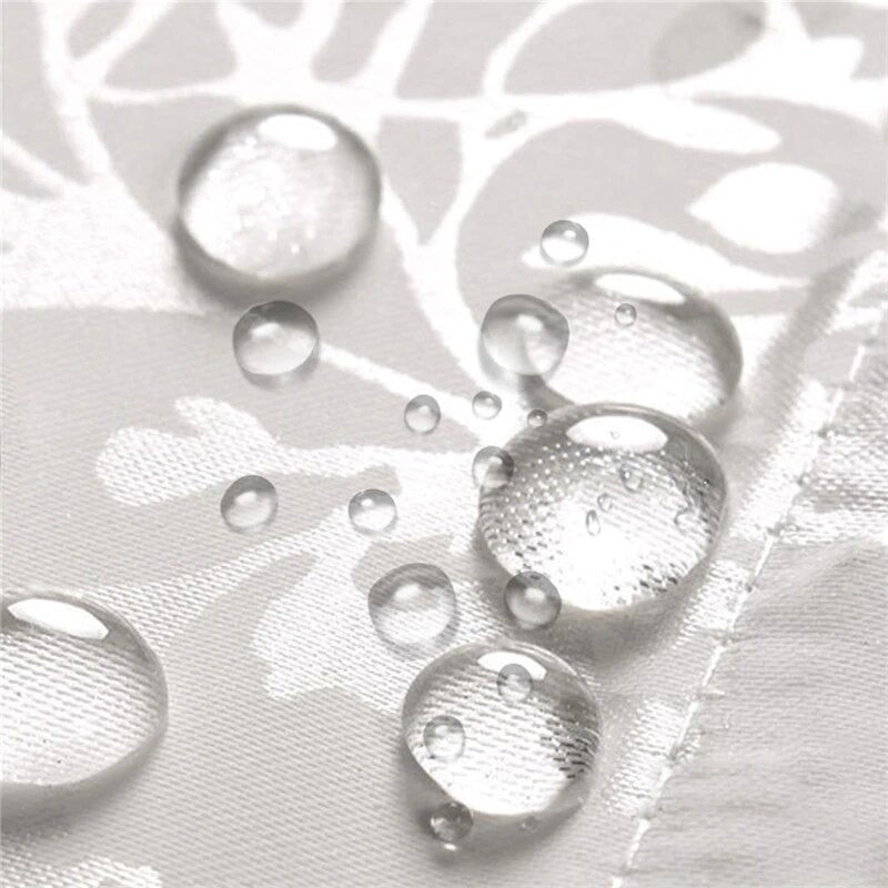 White matelasse curtain styled beside a bathtub in a bright bathroom