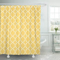 White quatrefoil trellis repeating evenly on a mustard yellow ground