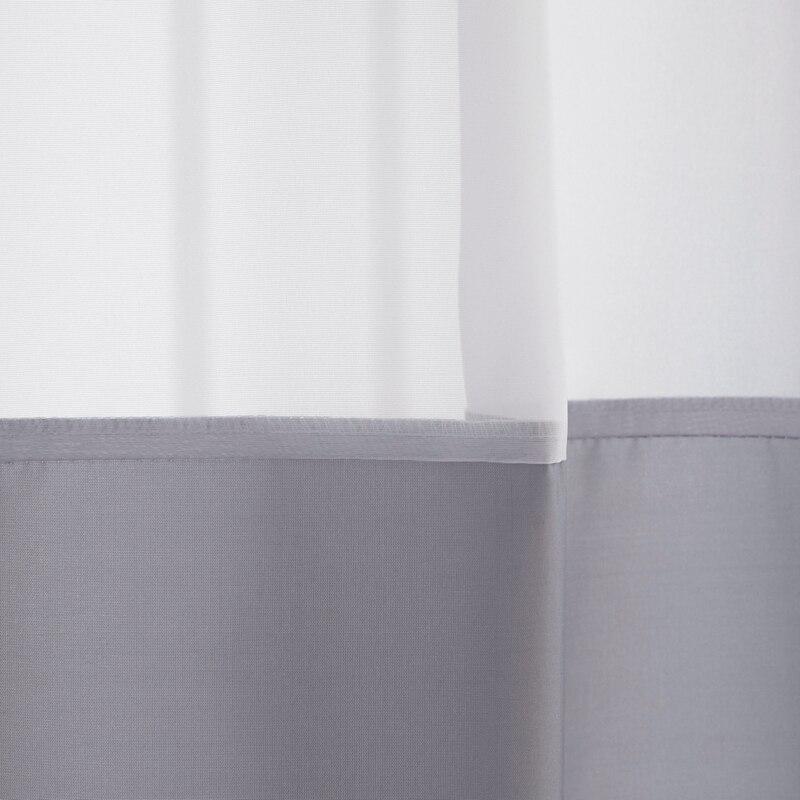 Full length grey curtain hanging straight in a minimal bathroom