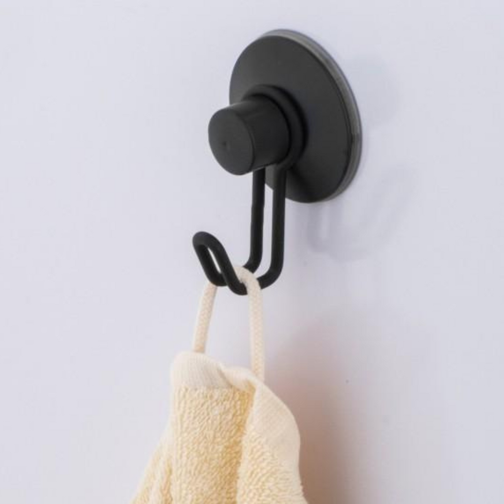 Slim matte black wall hook with a rounded minimalist profile
