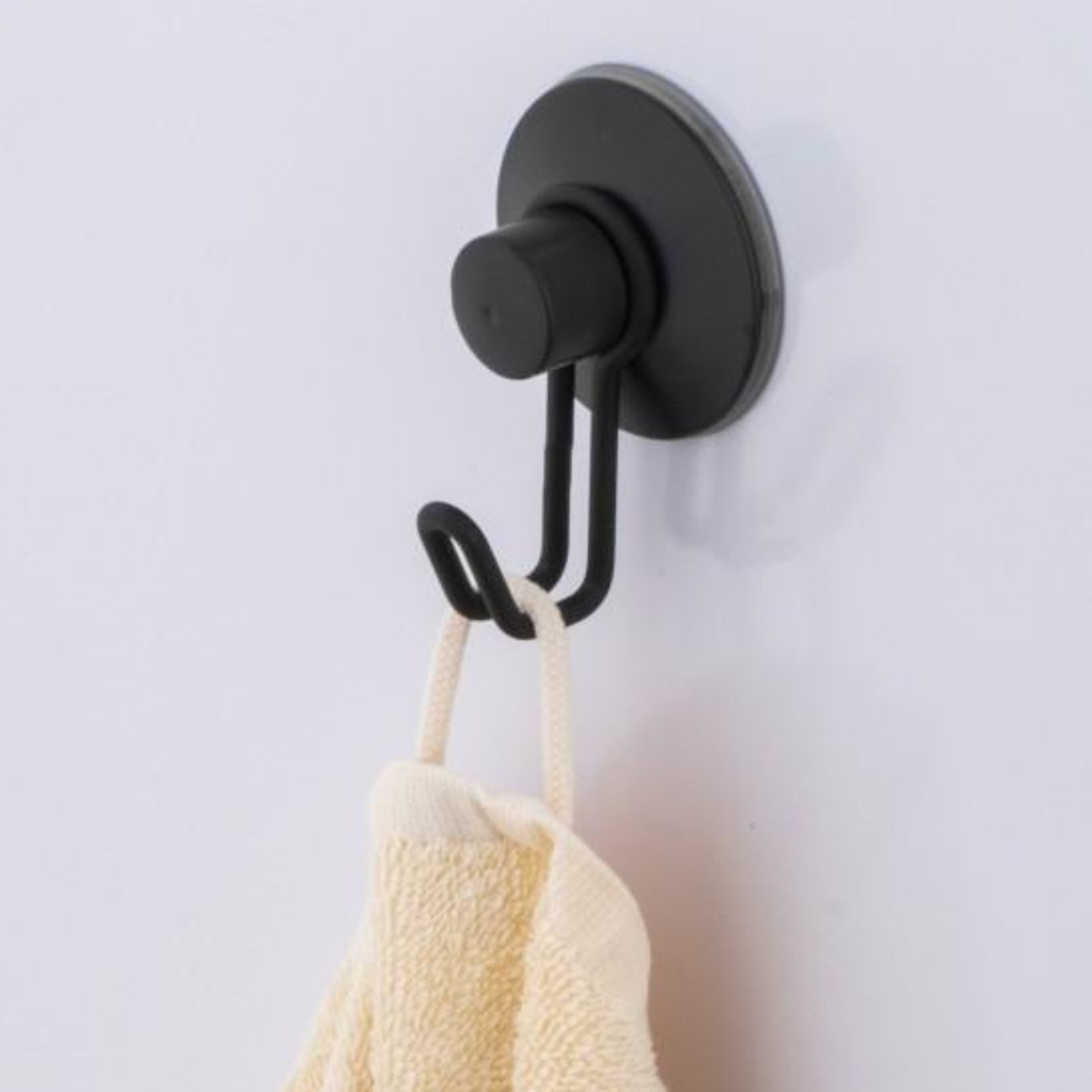 Slim matte black wall hook with a rounded minimalist profile