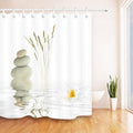 Three stacked beige stones and a white lotus on a pure white ground