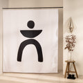 Bold black shape of a disc, bowl and two arched legs on bare white