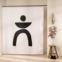 Bold black shape of a disc, bowl and two arched legs on bare white