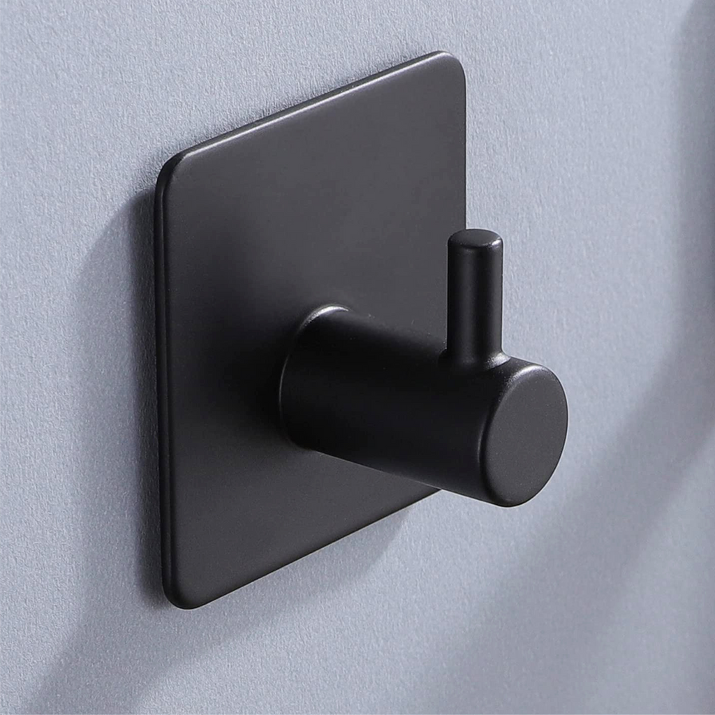 Matte black wall hook with a clean geometric profile on tile
