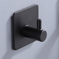 Matte black wall hook with a clean geometric profile on tile