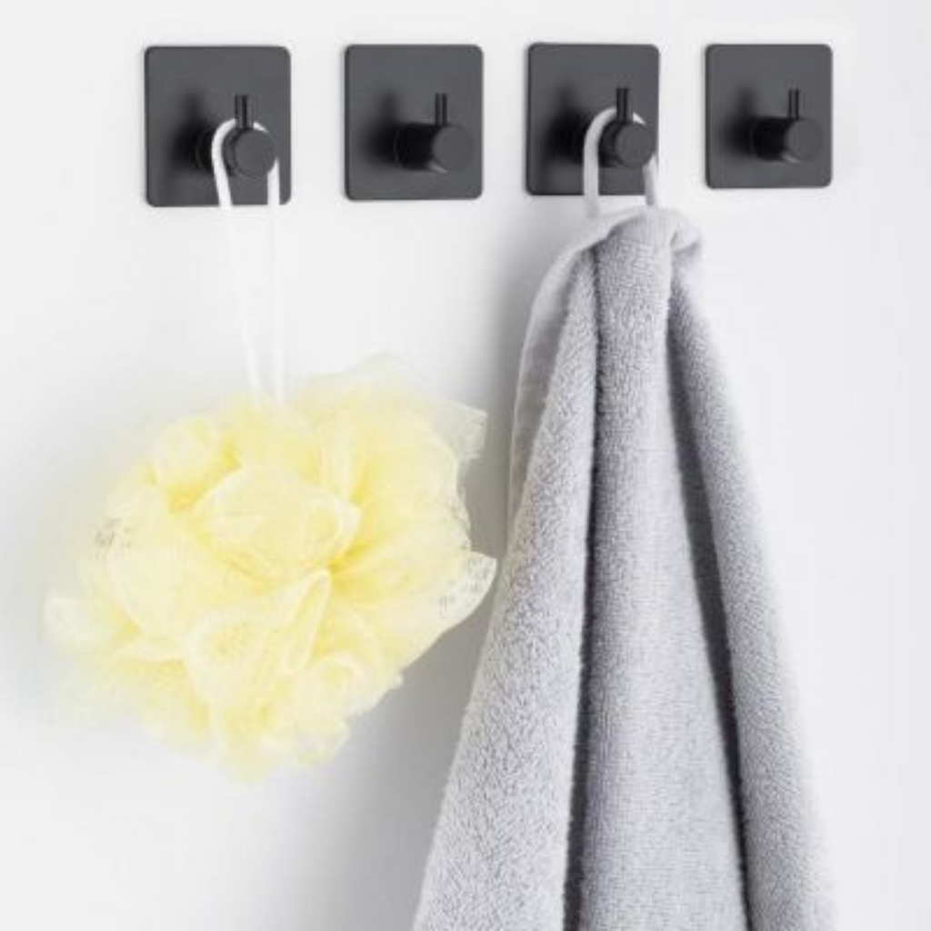 Side profile of the modern black hook against pale bathroom tiling