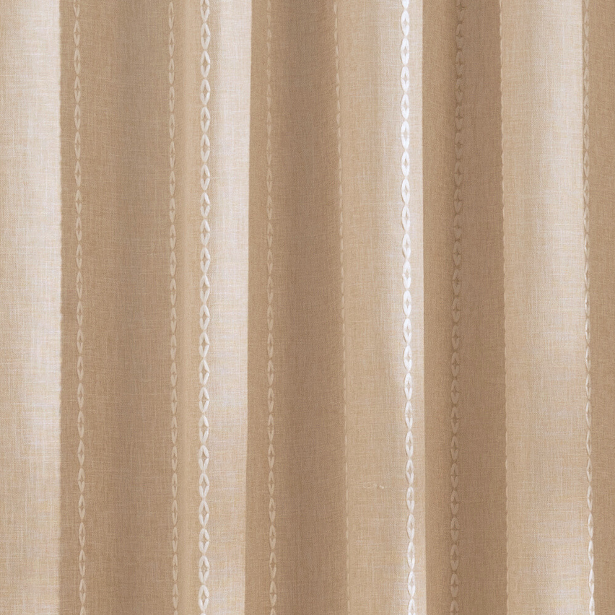 Weighted lower hem keeping the beige panel hanging evenly straight