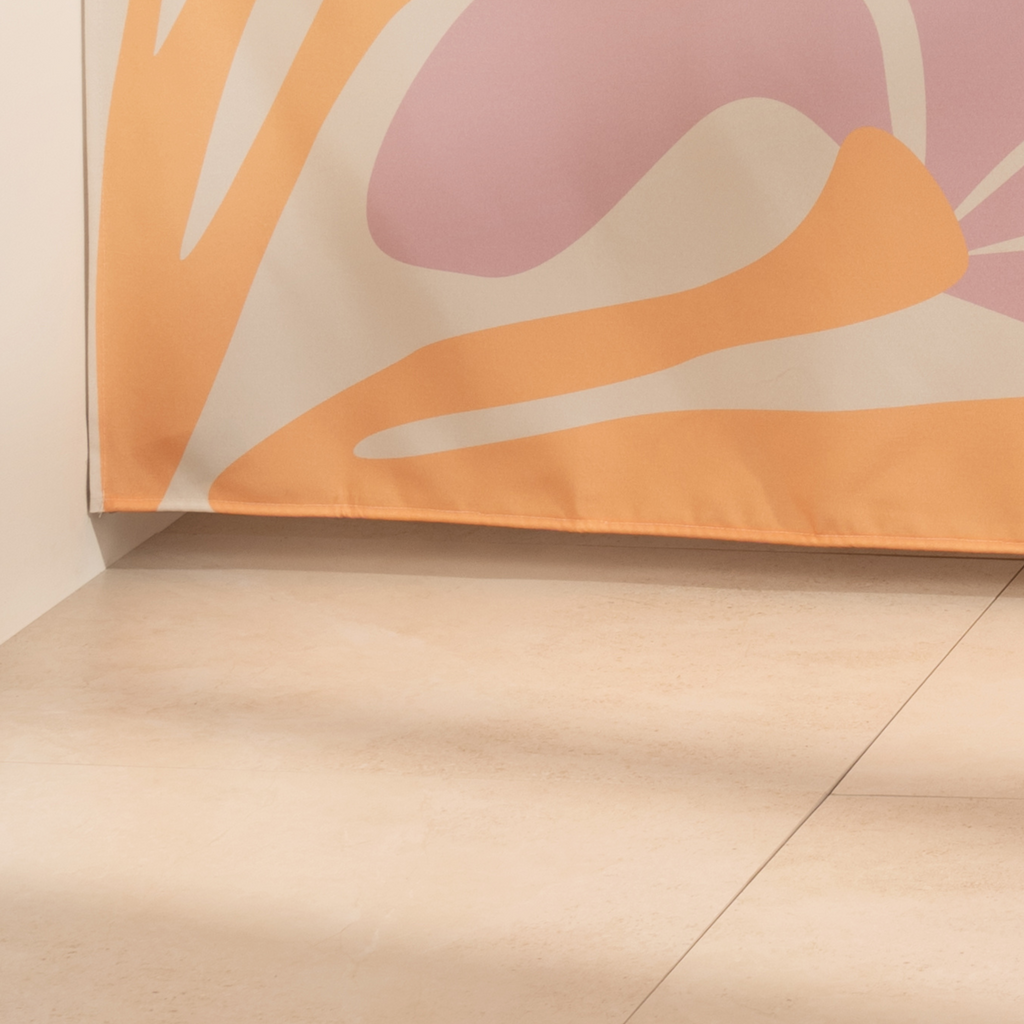 Full length modern floral curtain hanging beside a glass screen