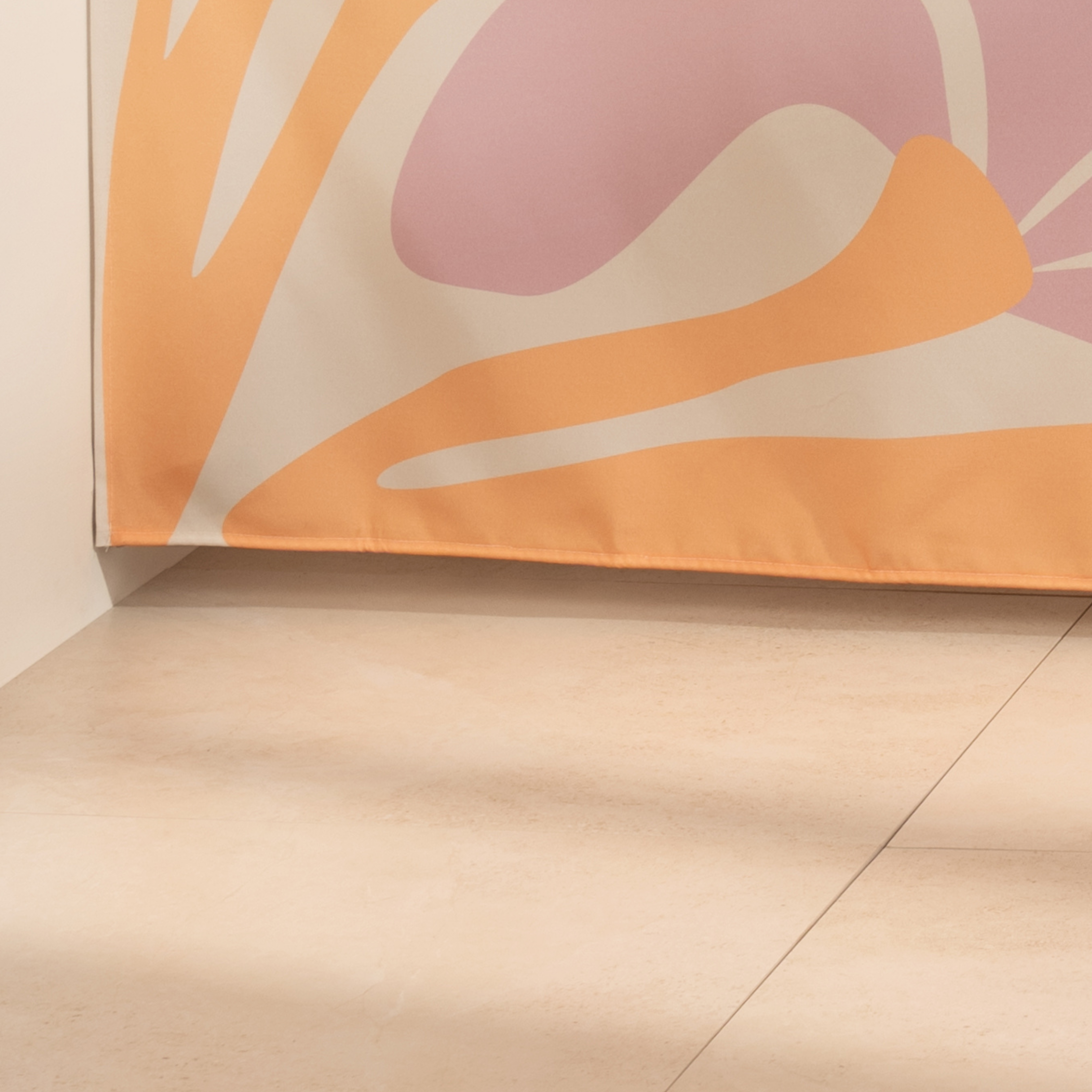 Full length modern floral curtain hanging beside a glass screen