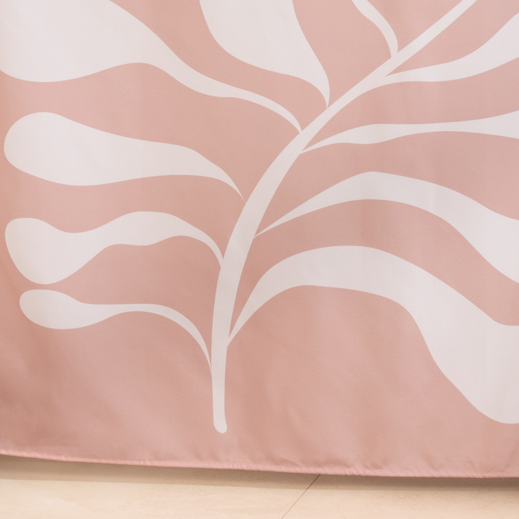 Full length pink and white leaf curtain hanging by a glass screen