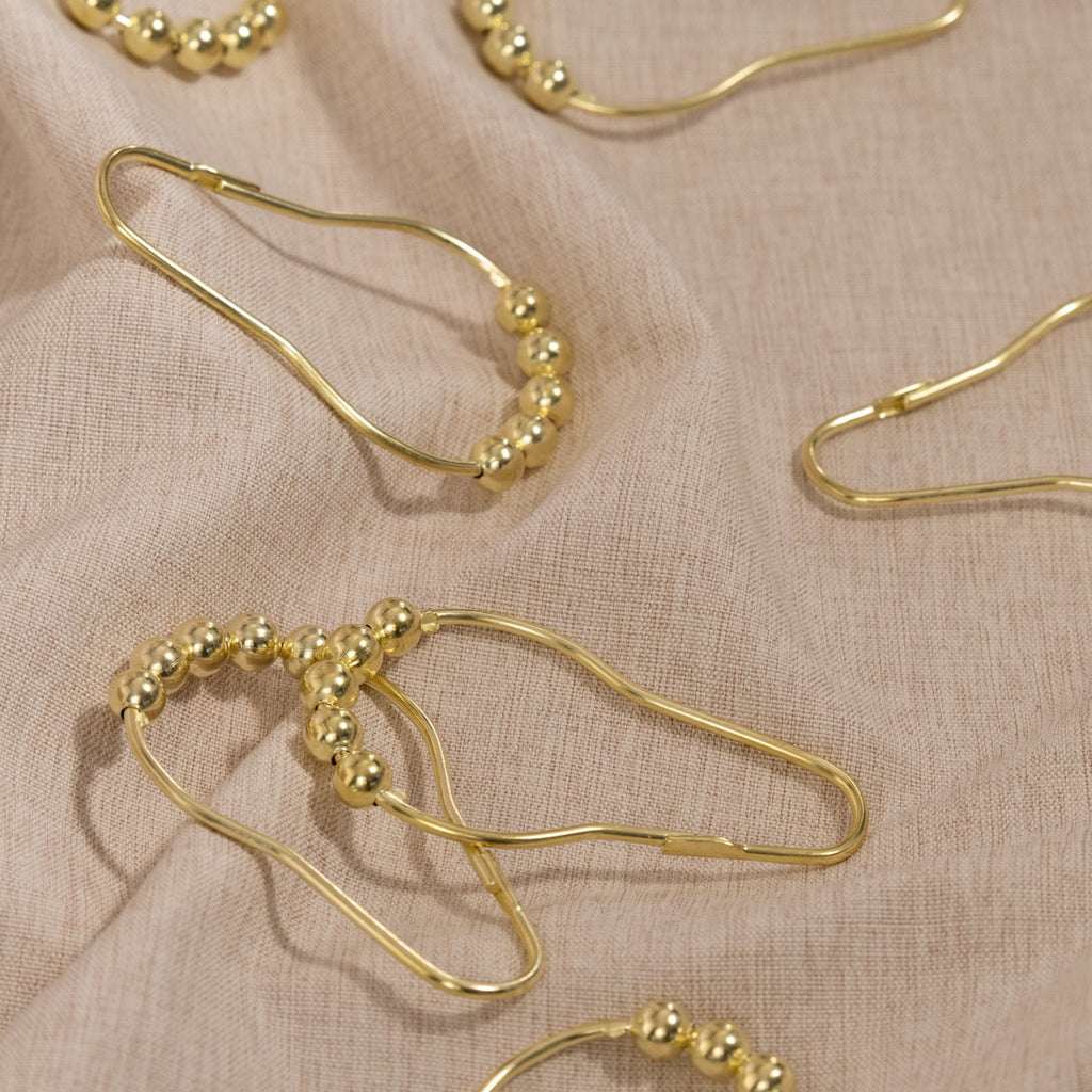 Close view of the gold ball crown on a single curtain ring