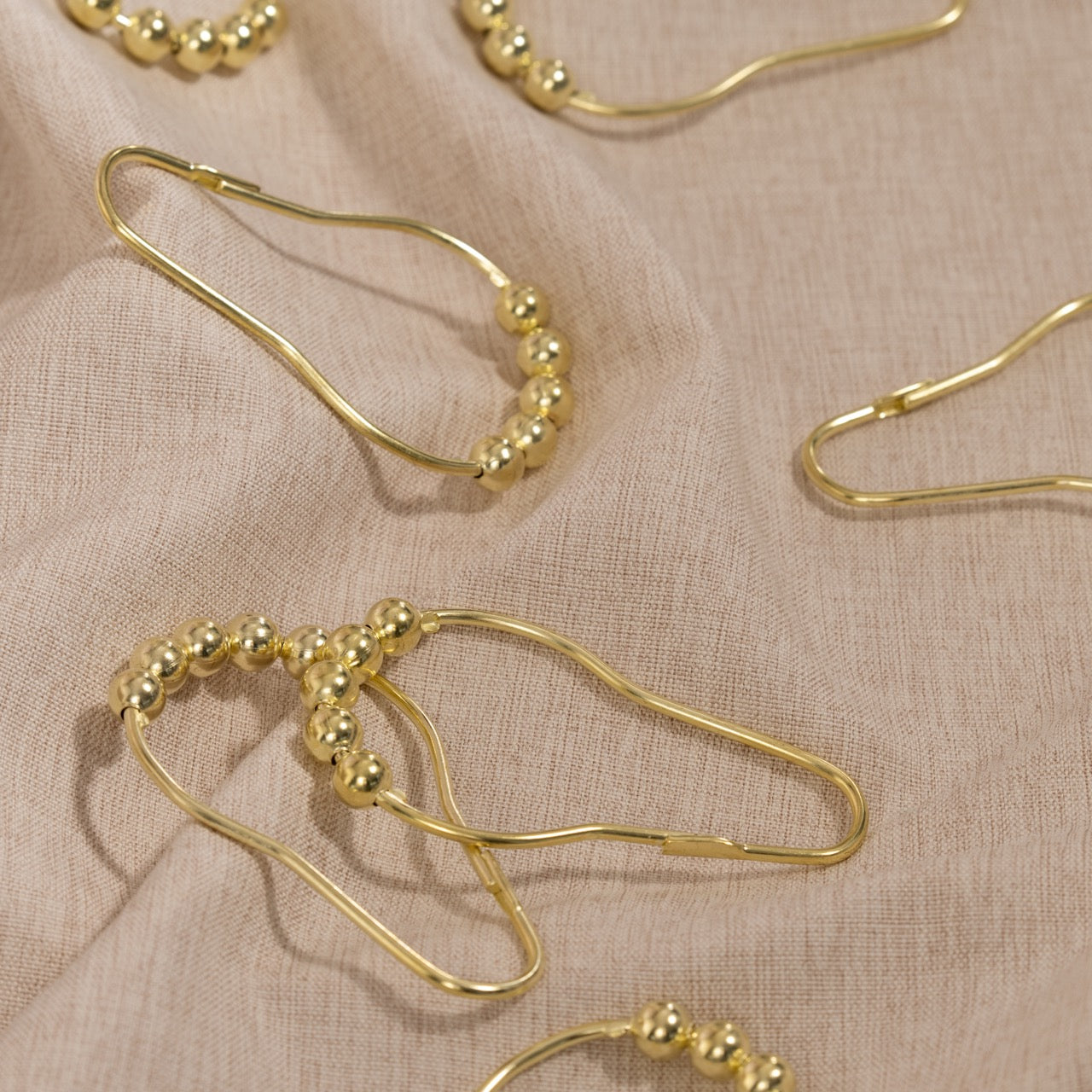 Close view of the gold ball crown on a single curtain ring