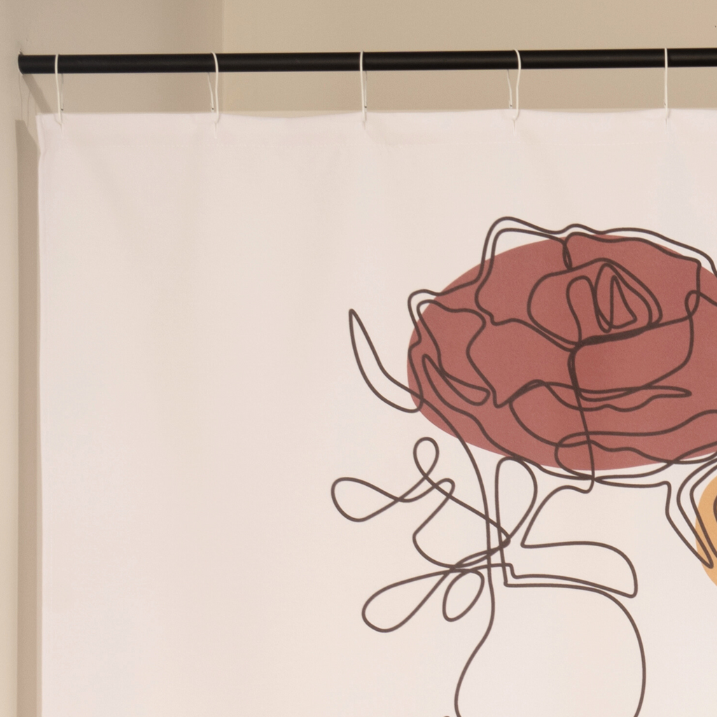 Full length rose portrait curtain hanging beside a glass screen