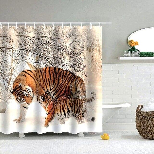 Adult tiger and cub standing in snow beneath frosted branches in winter light