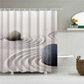 Beige sand raked in concentric circles with two smooth grey stones in front