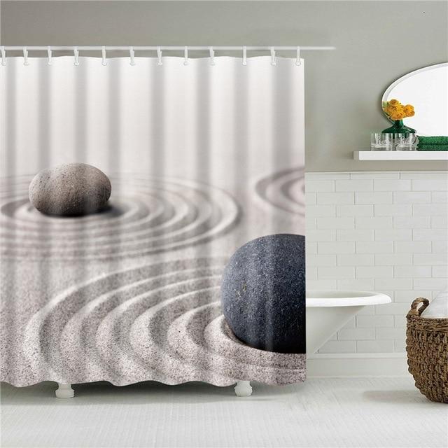 Beige sand raked in concentric circles with two smooth grey stones in front