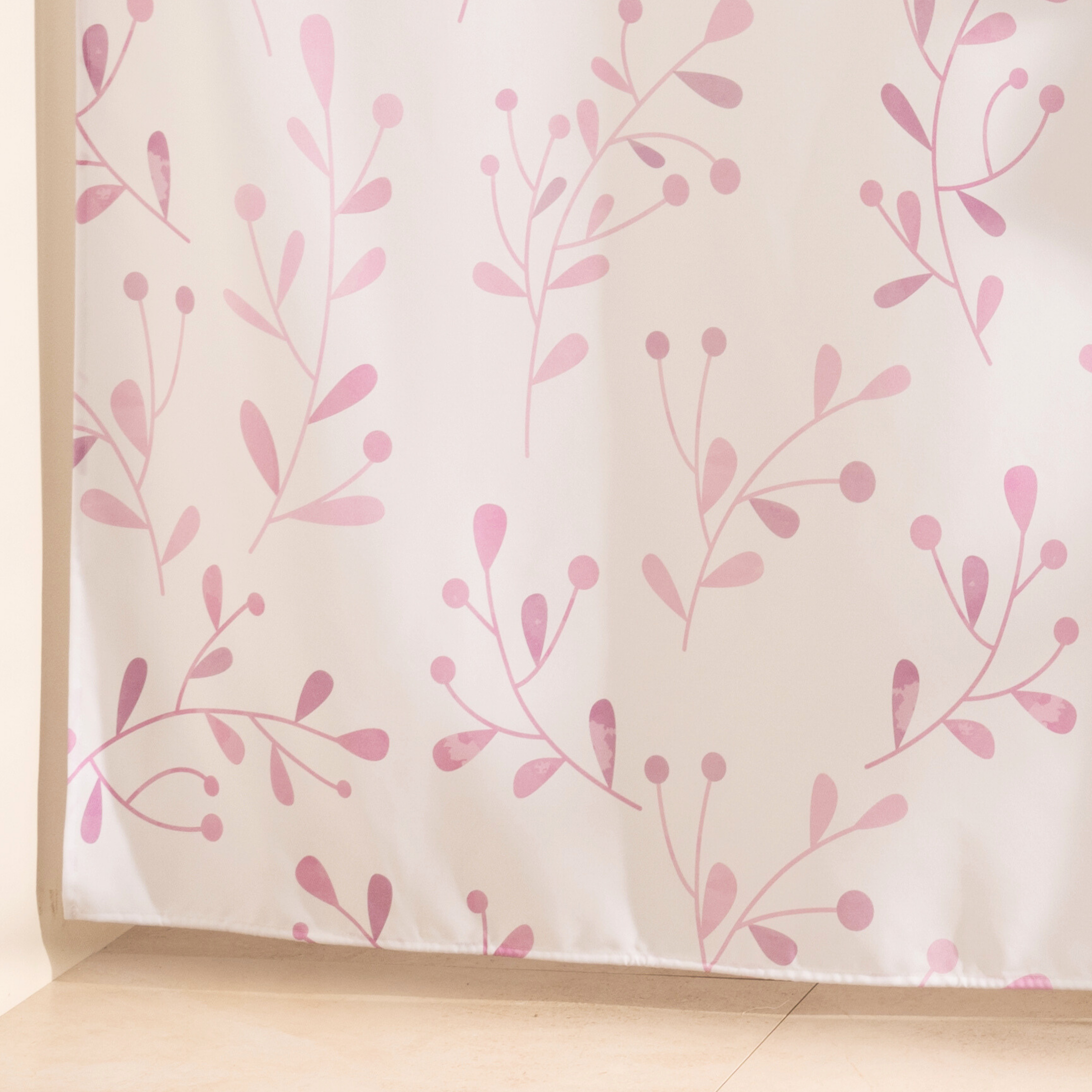 Full length neutral floral curtain hanging beside a glass screen