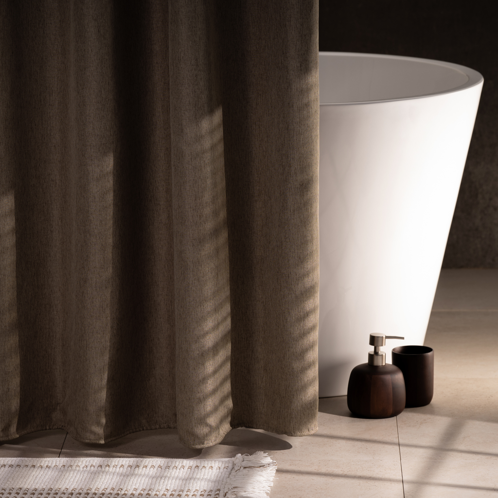 Neutral greige curtain styled in a warm minimal bathroom setting