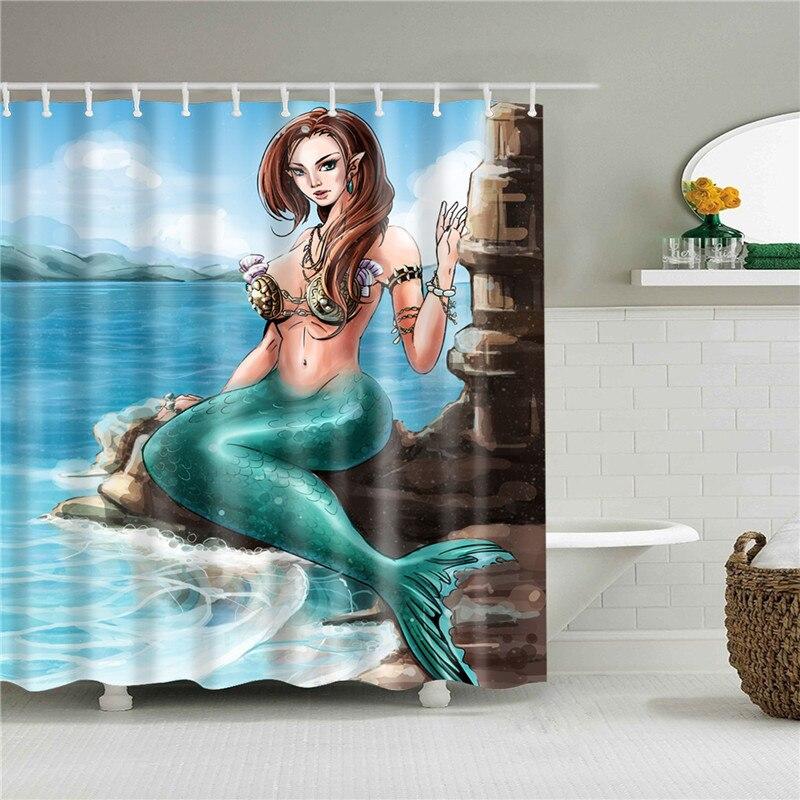 Mermaid with an emerald tail sitting on a rock before a blue sea