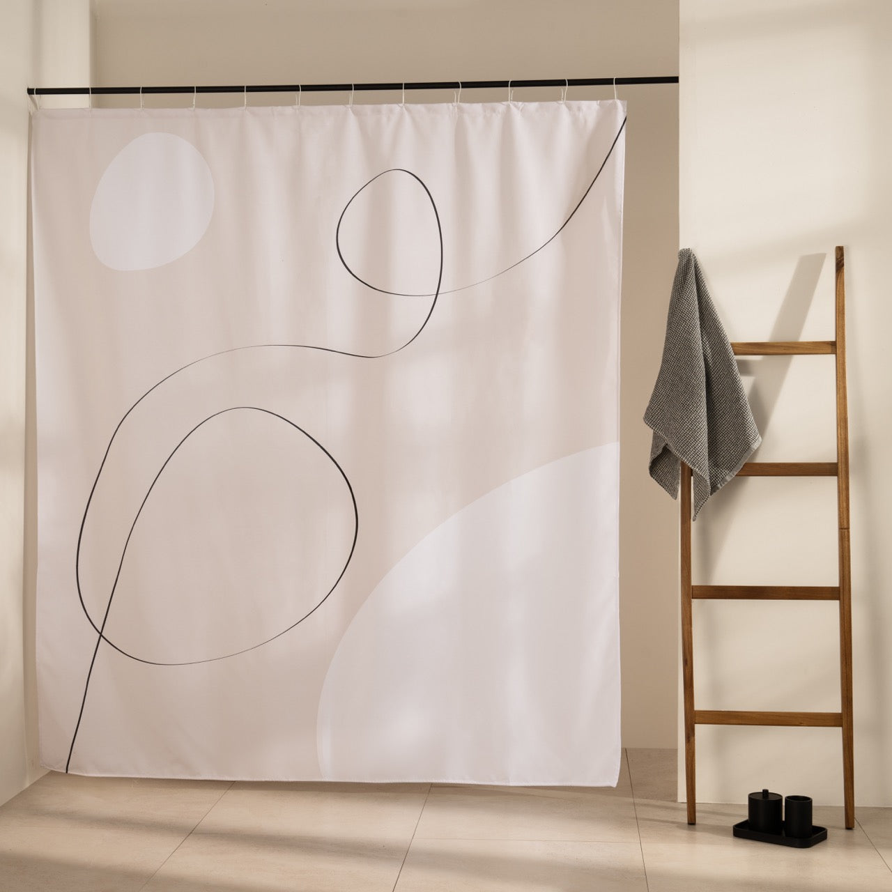 Soft cream panel marked by one looping black line and two tonal ovals