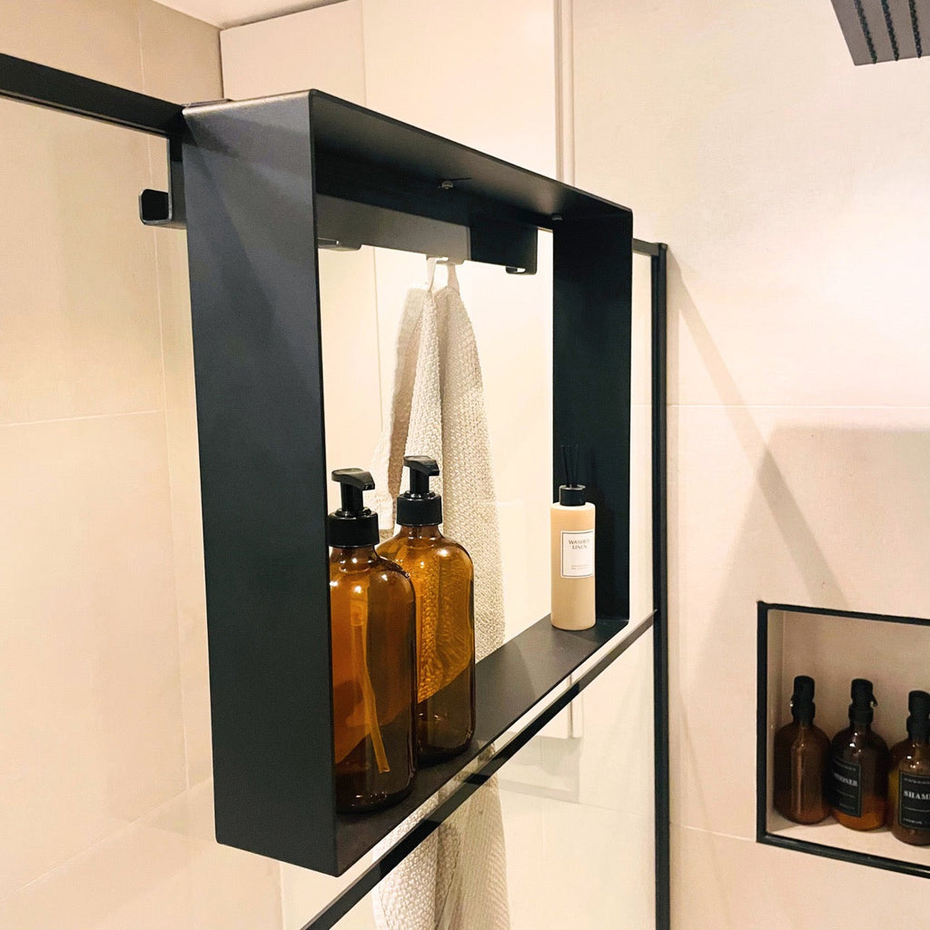 Drainage slots in the base of the black over-screen shower caddy