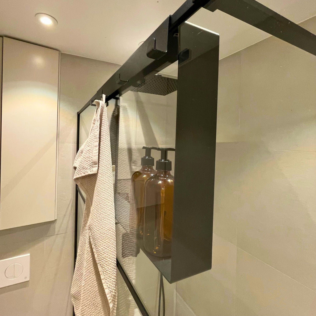 Black over-screen caddy styled in a modern walk in shower enclosure