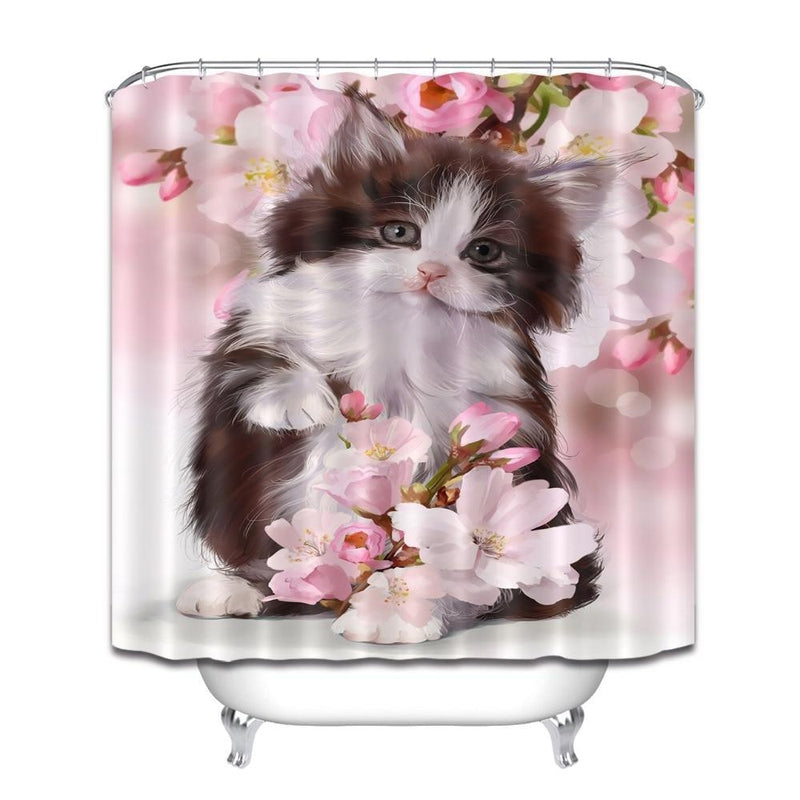 Close view of the pink blossom branches behind the kitten