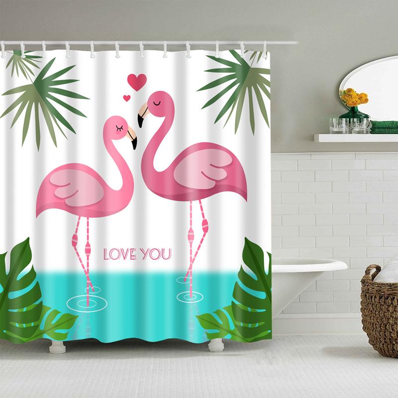 Two facing pink flamingos framed by green tropical leaves on a white ground