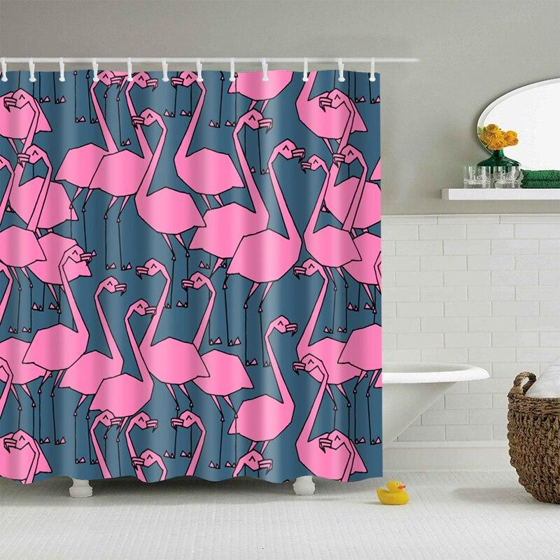 Bright pink flamingos outlined in black repeating over a greyed petrol blue ground