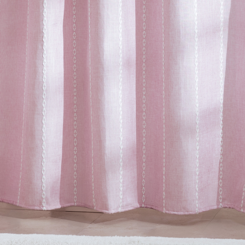 Full length powder pink curtain hanging beside a white bathtub