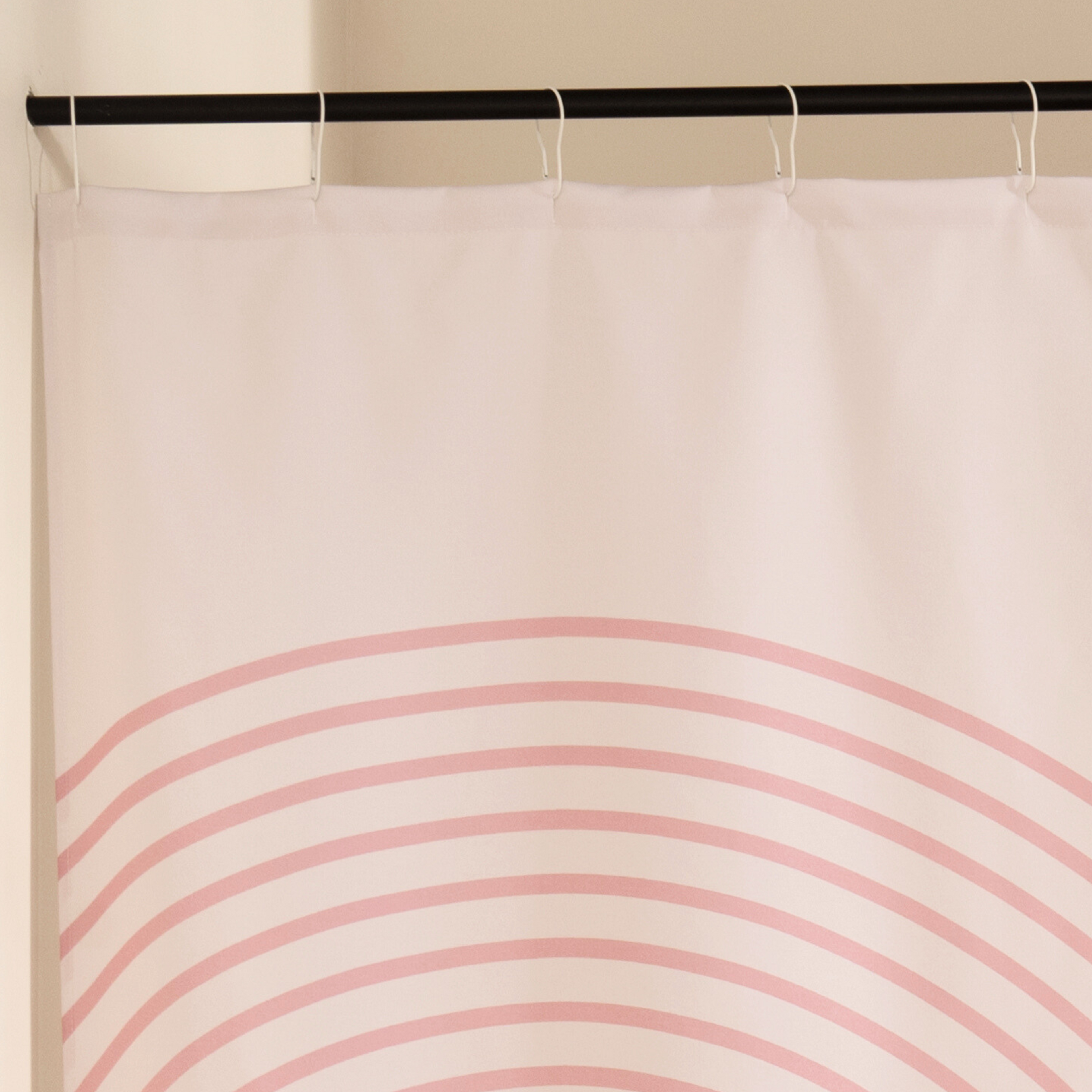 Full length pink retro curtain hanging beside a glass shower screen